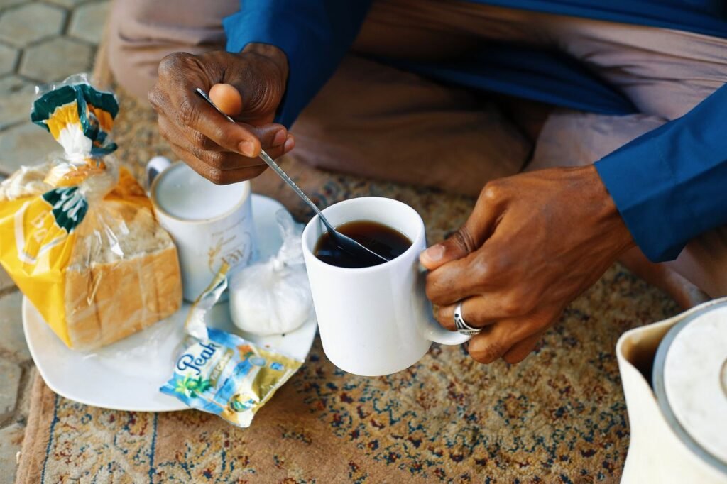 Enjoy a cultural breakfast with bread and tea in Abuja, Nigeria, depicting local morning routines.